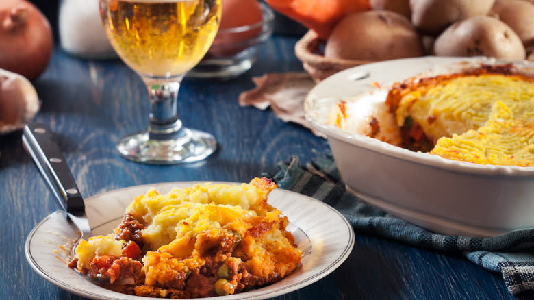 plate of shepherd's pie in front of beer and ingredients