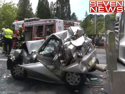 <p>A woman has amazingly survived an accident in which her car was sandwiched between two semi-trailers.</p>