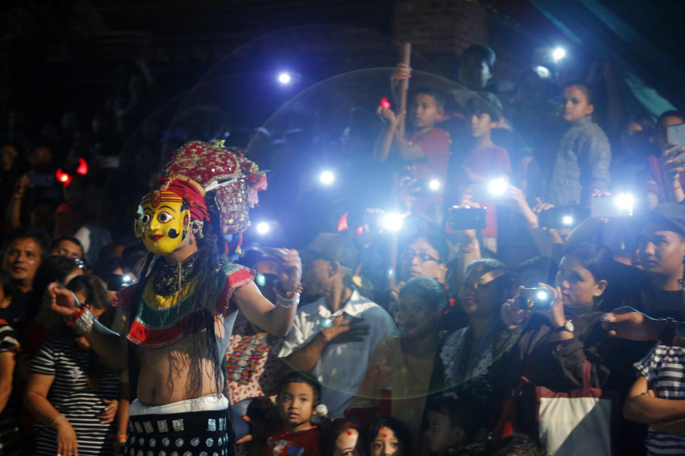 In this Sept. 22, 2018, photo, a mask dancer performs during Indra Jatra festival in Kathmandu, Nepal. For centuries, Nepal has celebrated the Indra Jatra festival of masked dancers, which officially begins the month-long festivities in the Hindu-dominated Himalyan nation. The dancers, who come from a variety of backgrounds, pull off this performance every year despite minimal financial support from the government and other sources, they say. (AP Photo/Niranjan Shrestha)