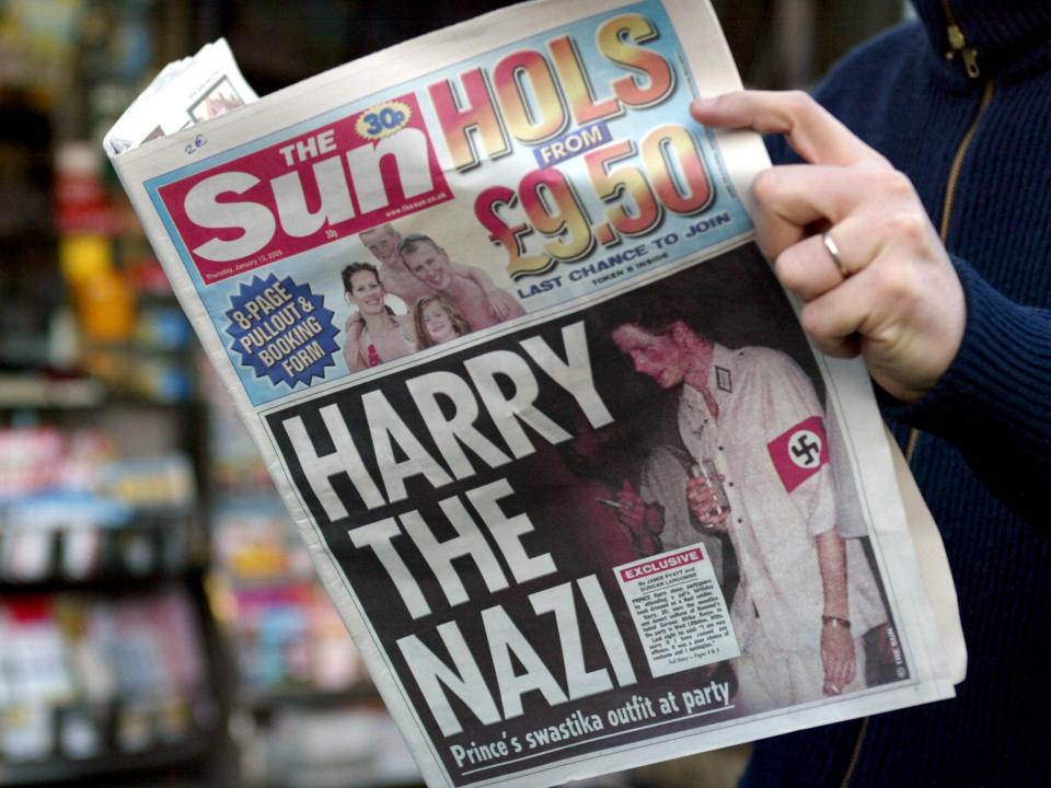 A man in Paris reads The Sun on 13 January 2005 as it carried photographs of Prince Harry which triggered outrage (GABRIEL BOUYS/AFP via Getty Images)