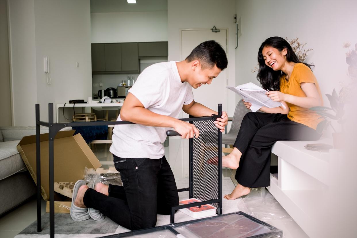 An Asian couple fixing a table.