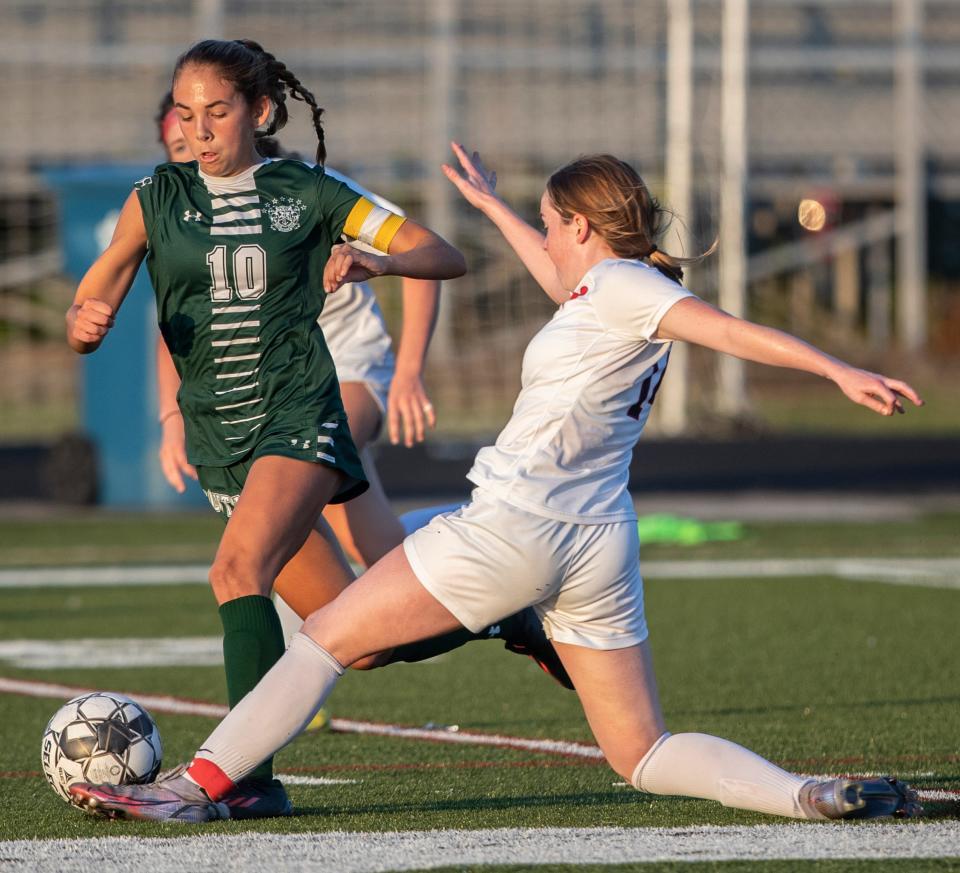 Sacred Heart's Christine Very, right, knocks the ball away from South Oldham's Betsy Huckaby, left. Aug. 24, 2022