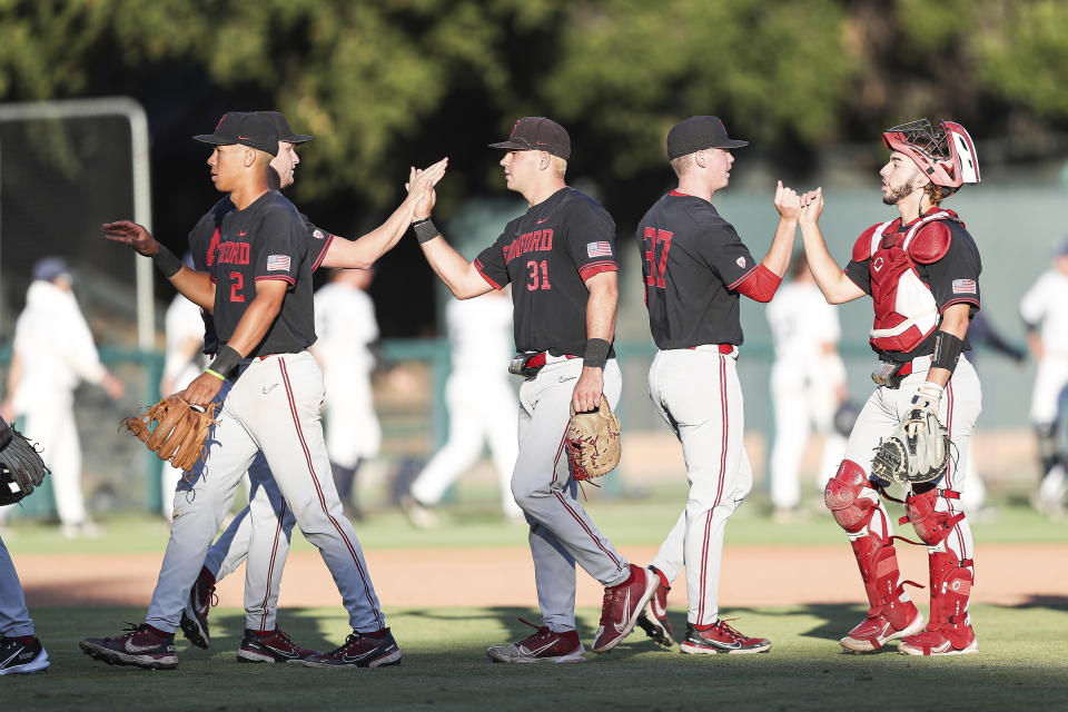 FILE- Stanford players celebrate after defeating Connecticut in an NCAA college baseball super regional tournament game on June 12, 2022, in Stanford, Calif. Stanford looks to rebound after going two games and out at the College World Series for the first time in 18 appearances.(AP Photo/Kavin Mistry, File)