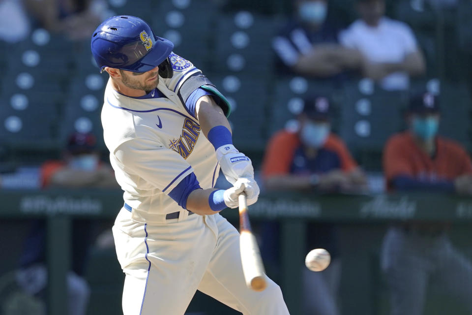 Seattle Mariners' Mitch Haniger hits an RBI-double during the seventh inning of a baseball game against the Houston Astros, Sunday, April 18, 2021, in Seattle. (AP Photo/Ted S. Warren)