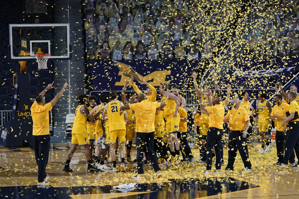 Michigan celebrates after winning the Big Ten title with a victory over Michigan State in an NCAA college basketball game Thursday, March 4, 2021, in Ann Arbor, Mich. (AP Photo/Carlos Osorio)