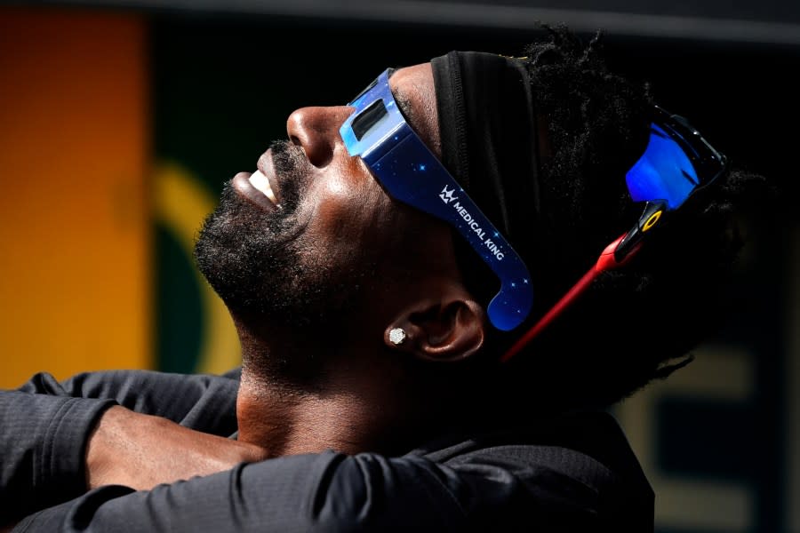 Pittsburgh Pirates’ Andrew McCutchen views the solar eclipse before a baseball game against the Detroit Tigers in Pittsburgh, Monday, April 8, 2024. (AP Photo/Gene J. Puskar)