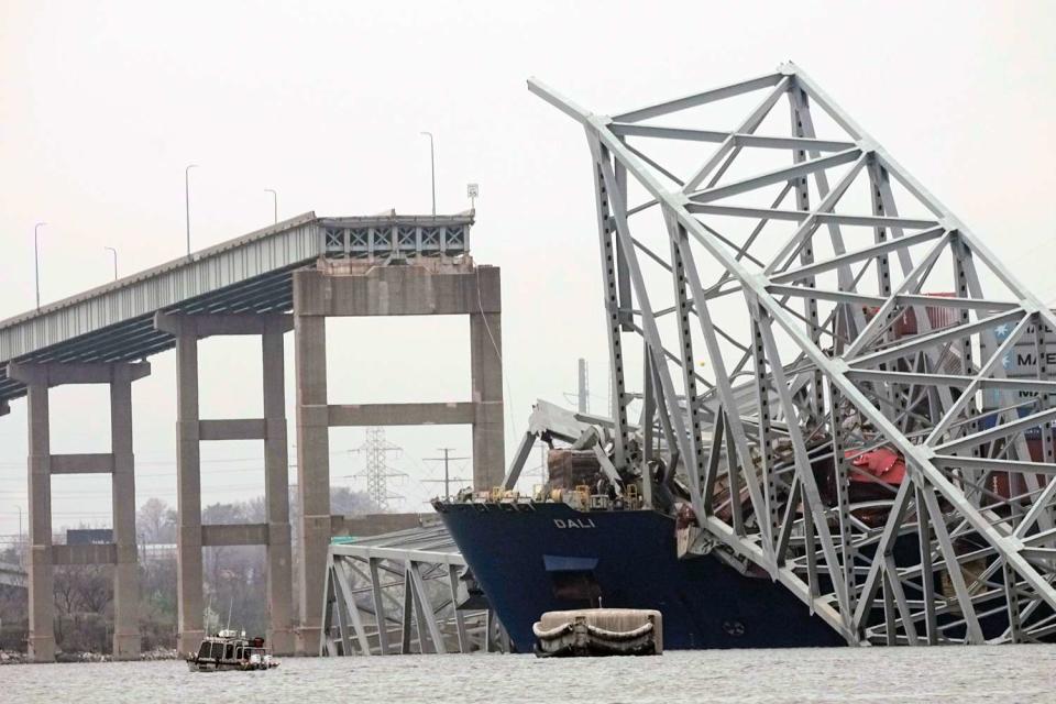 <p>AP Photo/Steve Helber</p> A cargo ship is stuck under the part of the structure of the Francis Scott Key Bridge after the ship hit the bridge Wednesday, March 27, 2024, in Baltimore, Md.