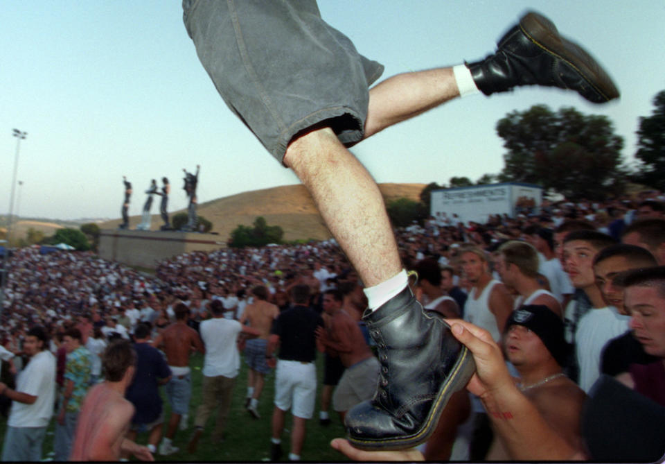 A mosher wearing Doc Martens takes flight.