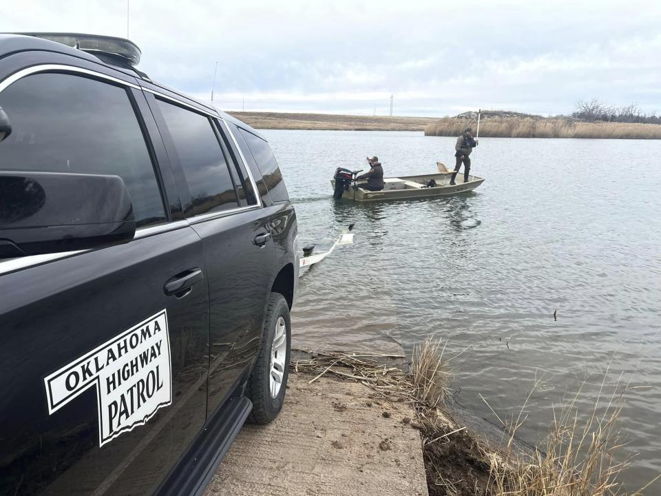 In this image provided by the Oklahoma Highway Patrol, troopers search a pond near Cyril, Okla, on Wednesday, Jan. 11, 2023, for Athena Brownfield, a 4-year-old girl missing since Tuesday, Jan, 10. Authorities have arrested two people in connection with the girl's disappearance while they continued searching for her Friday, Jan 13, 2023. (Trooper Eric Foster/Oklahoma Highway Patrol via AP)