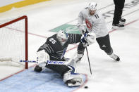 Vancouver Canucks goalie Jacob Markstrom (25) blocks a shot as Florida Panthers forward Jonathan Huberdeau (11) closes in during the NHL hockey All Star final game Saturday, Jan. 25, 2020, in St. Louis. (AP Photo/Scott Kane)