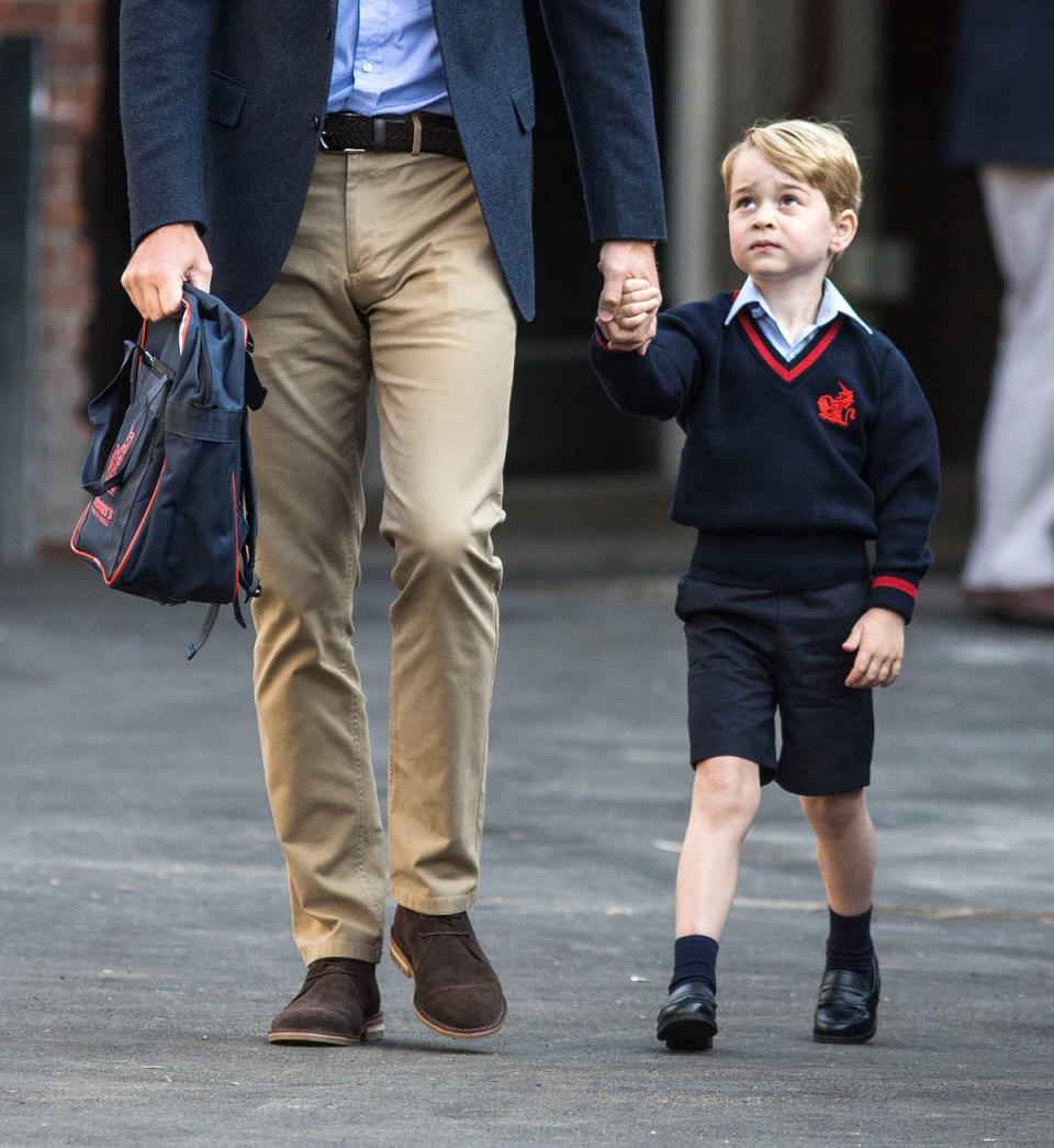 Prince George holds hands with the Duke of Cambridge as he arrives at Thomas’s Battersea (Richard Pohle/The Times/PA) (PA Archive)