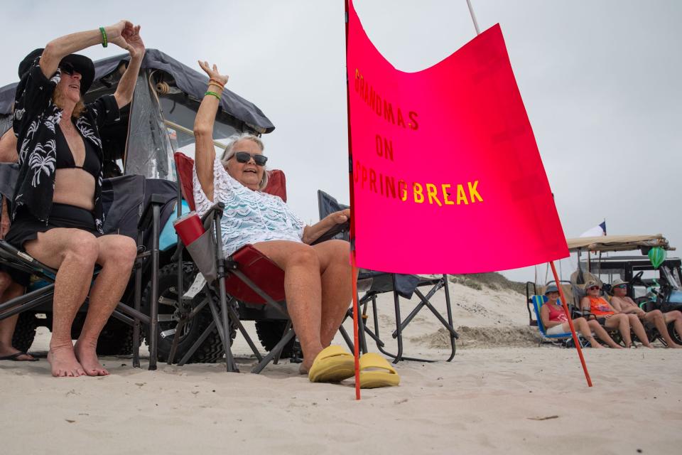 A sign reading "Grandmas on Spring Break" is posted in front of Audrey Gillespie, left, a part-time resident of New Braunfels, and Linda Reiman, a Winter Texan from Iowa, on Friday, March 15, 2024, in Port Aransas, Texas.