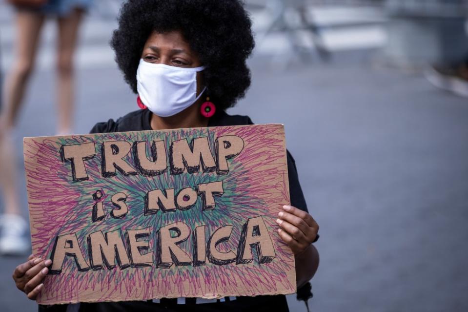 MANHATTAN, NY – JUNE 14: A protester holds a homemade sign that says, “Trump is Not America” in the middle of the crowd that gathered at Columbus Circle. (Photo by Ira L. Black/Corbis via Getty Images)”n”n”n