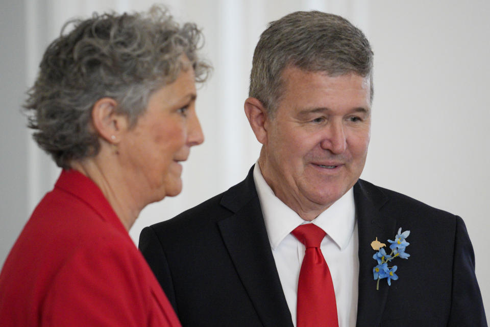 West Virginia gubernatorial candidate Mac Warner, right, speaks with supporters at a campaign event at the Charleston Women's Club in Charleston, W.Va., Thursday, May 4, 2023. (AP Photo/Jeff Dean)