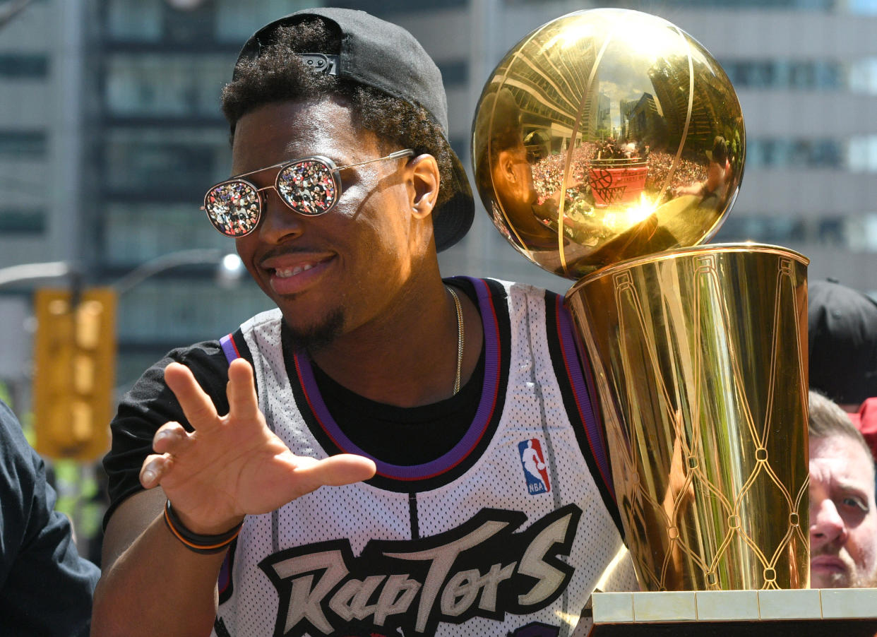 Jun 17, 2019; Toronto, Ontario, Canada;  Toronto Raptors guard Kyle Lowry shows off the Larry O'Brien trophy to fans during a parade through downtown Toronto to celebrate their NBA title. Mandatory Credit: Dan Hamilton-USA TODAY Sports