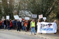 Demonstrators hold anti-Tesla posters during a protest against plans by U.S. electric vehicle pioneer Tesla to build its first European factory and design center near Berli