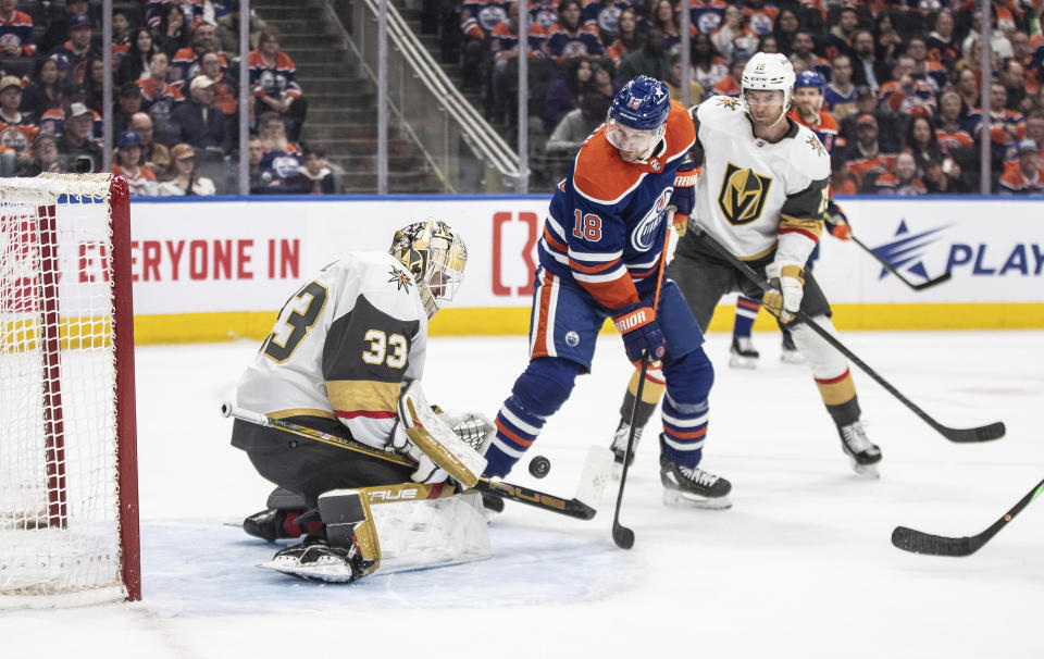 Vegas Golden Knights goalie Adin Hill (33) makes the save on Edmonton Oilers' Zach Hyman (18) during the second period of an NHL hockey game in Edmonton, Alberta on Wednesday April 10, 2024.(Jason Franson/The Canadian Press via AP)