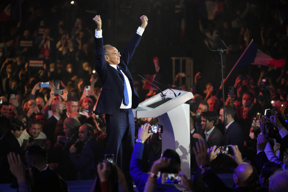 Far-right presidential candidate Eric Zemmour raises his hands toward supporters during a campaign rally at the Palais des Victoires in Cannes, southern France, Saturday, Jan. 22, 2022. (AP Photo/Daniel Cole)