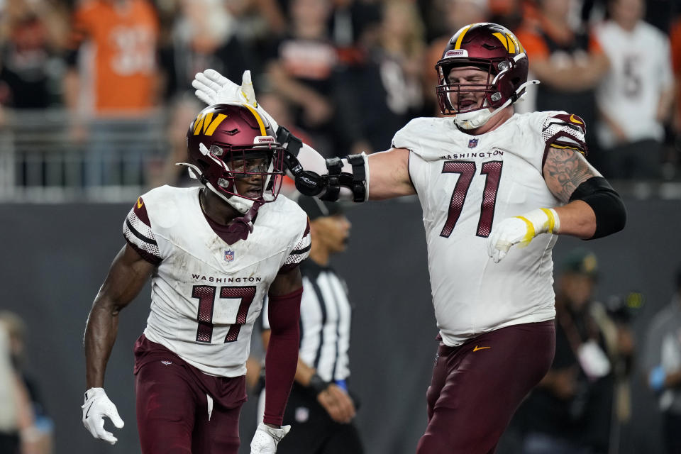 Washington Commanders wide receiver Terry McLaurin (17) celebrates with teammate Andrew Wylie (71) after catching a 27-yard touchdown pass during the second half of an NFL football game against the Cincinnati Bengals, Monday, Sept. 23, 2024, in Cincinnati. (AP Photo/Carolyn Kaster)