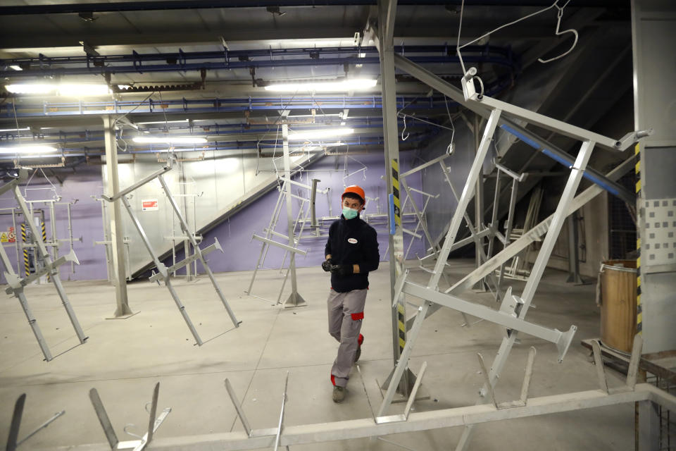 A worker assembles frames for hospital beds, at the Linet factory in Slany, Czech Republic, Monday, Oct. 19, 2020. A Czech hospital bed maker with a full order book received one more order that was impossible to turn down. The company was approached by Prime Minister Andrej Babis to deliver beds for a military field hospital for 500 COVID-19 patients, to be built this week in Prague. (AP Photo/Petr David Josek)