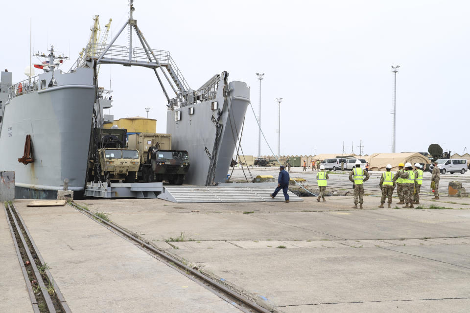 U.S. army vehicles disembark from a vessel at Albania's main port of Durres, Saturday, May 1, 2021. Florida National Guard's 53rd Infantry Brigade Combat Team were being discharged from the USNS Bob Hope ahead of a two-week training of up to 6,000 U.S. troops in six Albanian military bases, as part of the Defender-Europe 21 large-scale U.S. Army-led exercise. (AP Photo/Hektor Pustina)