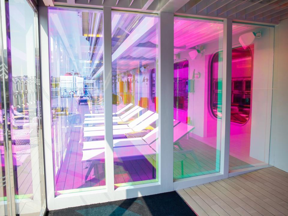 a rainbow windowed doorway leading to the outdoor deck