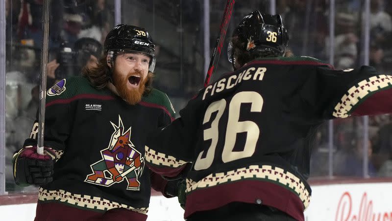 Arizona Coyotes center Liam O’Brien celebrates with right wing Christian Fischer (36) after scoring a goal against the Vancouver Canucks during the first period of an NHL hockey game Thursday, April 13, 2023, in Tempe, Ariz.