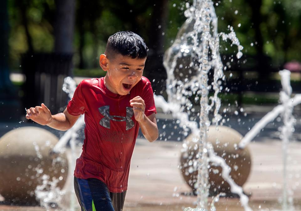 (5/28/22)Eight-year-old Anthony Jimenez plays in the cool spray of the interactive fountain on it's opening day at the Weber Point Events Center in downtown Stockton on Saturday, May 29, 2022. The fountain and park will be open daily from 11 a.m. to 6:30 p.m. trough Sept. 5 unless Weber Point is hosting a special event. CLIFFORD OTO/THE STOCKTON RECORD