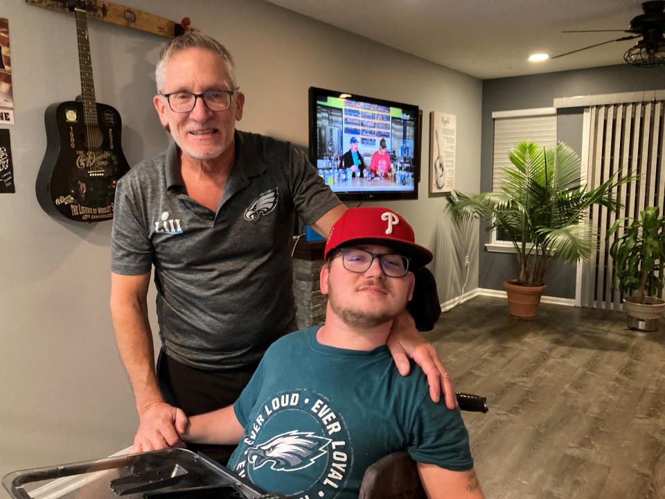 Austin Lauer (right) with his father George Lauer in their Manchester home.