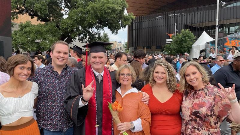 John Peyton celebrates his accomplishment with his family after Friday night's graduation ceremony for the Moody College of Communication. Peyton, 64, finished the degree that he had begun pursuing at UT in the 1990s.