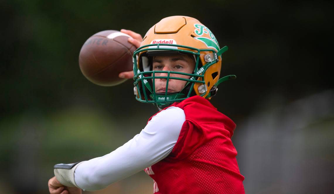 Tumwater quarterback Jaxon Budd runs through drills during preseason football practice at Tumwater District Stadium in Tumwater, Washington, on Thursday, Aug. 22, 2024.