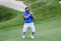 Team Europe's Jon Rahm reawcts to a mkissed putt on the 18th hole during a four-ball match the Ryder Cup at the Whistling Straits Golf Course Friday, Sept. 24, 2021, in Sheboygan, Wis. (AP Photo/Ashley Landis)