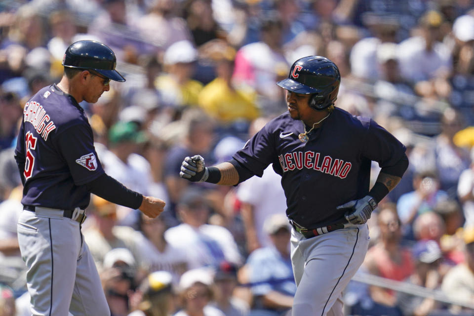 Cleveland Guardians' Jose Ramirez reacts with third base coach Mike Sarbaugh after hitting a home run during the fourth inning of a baseball game against the San Diego Padres, Wednesday, Aug. 24, 2022, in San Diego. (AP Photo/Gregory Bull)
