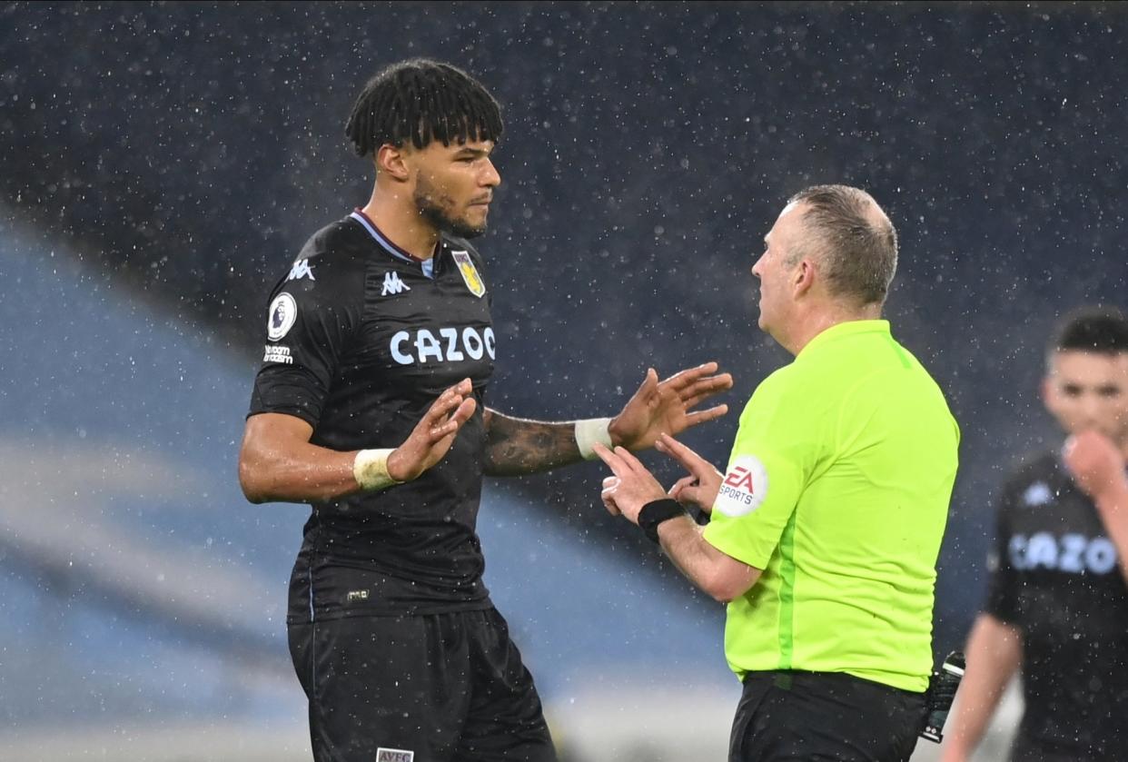 Tyrone Mings speaks to referee Jon Moss (AP)