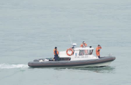 Russian Emergencies Ministry members sail on a boat near the crash site of Russian military Tu-154 plane in the Black Sea off the coast of the Sochi suburb of Khosta, Russia, Russia December 25, 2016. REUTERS/Yevgeny Reutov