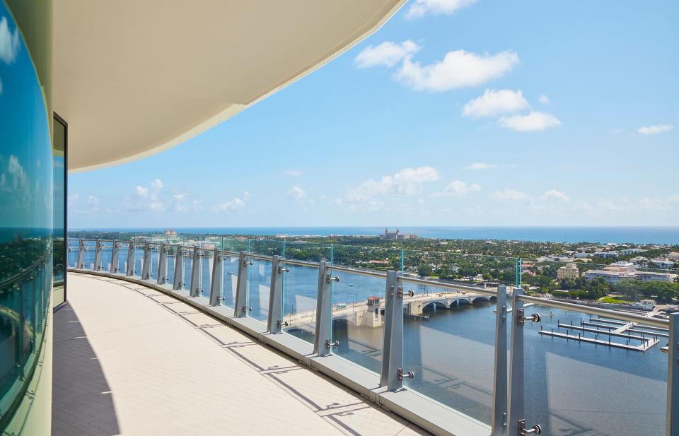 The glass-railed balcony of condominium 22C at The Bristol looks out to Palm Beach and the Atlantic Ocean, with the Royal Park Bridge, center, spanning the Intracoastal Waterway.