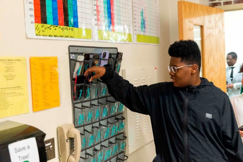Jamaal Wellman places his phone in a caddy at the start of a seventh-grade social studies class at Rolesville Middle School on March 27.