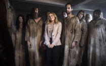 This image released by CBS shows Rose McIver, center, in a scene from the comedy series "Ghosts." (CBS via AP)