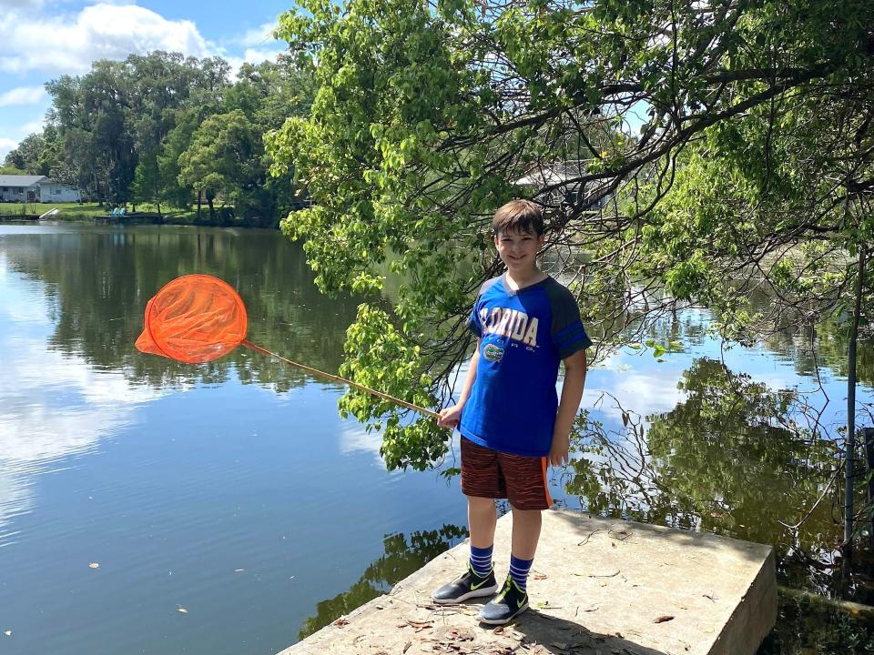 Ashley Archambault's son fishing on a lake.