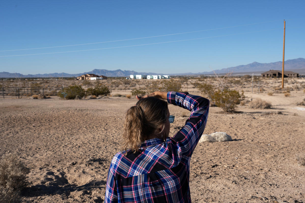 Jeanne Wright looks off her property in Pahrump, Nev., on Nov. 27, 2021. Surrounding her and her neighbors is federal land where the proposed Rough Hat solar project could be constructed. (Bridget Bennett for NBC News)