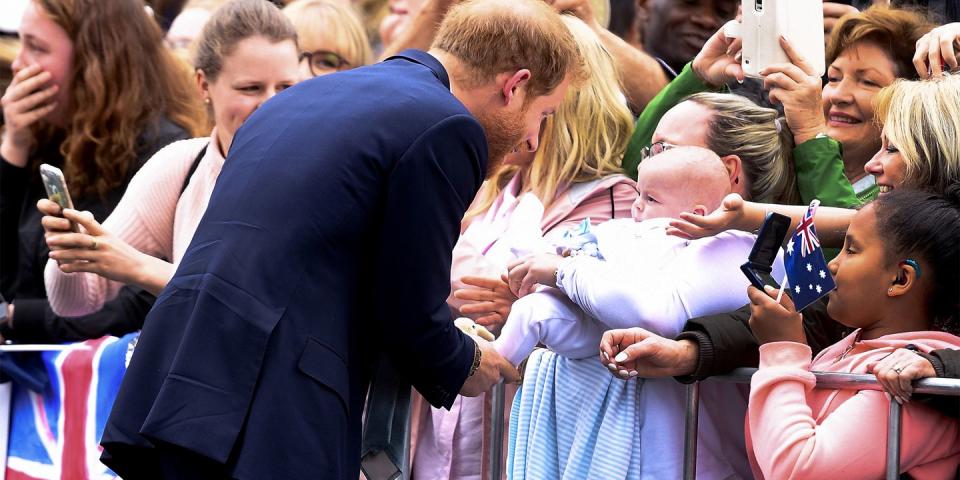 <p>Prince Harry meets a baby.</p>