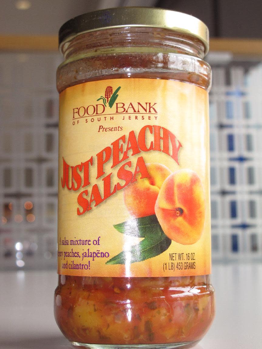 A jar of Just Peachy Salsa produced for sale by the Food Bank of South Jersey is displayed at the Campbell Soup Co. headquarters in Camden, N.J., on Wednesday, Aug. 1, 2012. Campbell and other firms are donating ingredients, materials and manufacturing for the salsa. (AP Photo/Geoff Mulvihill)