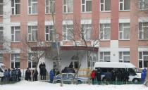 Interior Ministry members in uniform and other authorities gather outside a high school, where a student shot a teacher and a police officer dead and held more than 20 other students hostage, on the outskirts of Moscow, February 3, 2014. A Moscow high-school student shot a teacher and a police officer dead and held more than 20 other students hostage in a classroom on Monday before he was disarmed and detained, police said, just days before Russia hosts the Winter Olympics. (REUTERS/Maxim Shemetov)