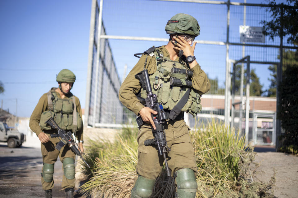 Israeli soldiers secure the village of Avivim on the Israel-Lebanon border, Monday, Sept. 2, 2019. Hezbollah militants on Sunday fired a barrage of anti-tank missiles into Israel, prompting a reprisal of heavy Israeli artillery fire in a rare burst of fighting between the bitter enemies. (AP Photo/Ariel Schalit)