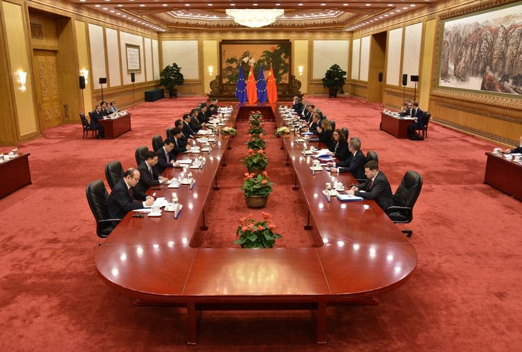 <span class="caption">Roundtable meeting at the Great Hall of the People at the 18th EU-China Summit in Beijing in July 2016.</span> <span class="attribution"><a class="link " href="https://www.flickr.com/photos/eeas/27999826310/" rel="nofollow noopener" target="_blank" data-ylk="slk:European External Action Service.;elm:context_link;itc:0;sec:content-canvas">European External Action Service.</a>, <a class="link " href="http://creativecommons.org/licenses/by-nc/4.0/" rel="nofollow noopener" target="_blank" data-ylk="slk:CC BY-NC;elm:context_link;itc:0;sec:content-canvas">CC BY-NC</a></span>