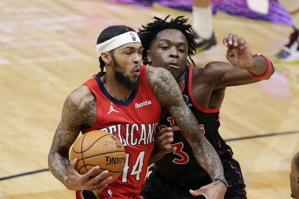 New Orleans Pelicans forward Brandon Ingram (14) drives to the basket as Toronto Raptors forward OG Anunoby (3) defends during the second half of an NBA basketball game on Saturday, Jan. 2, 2021, in New Orleans. (AP Photo/Butch Dill)