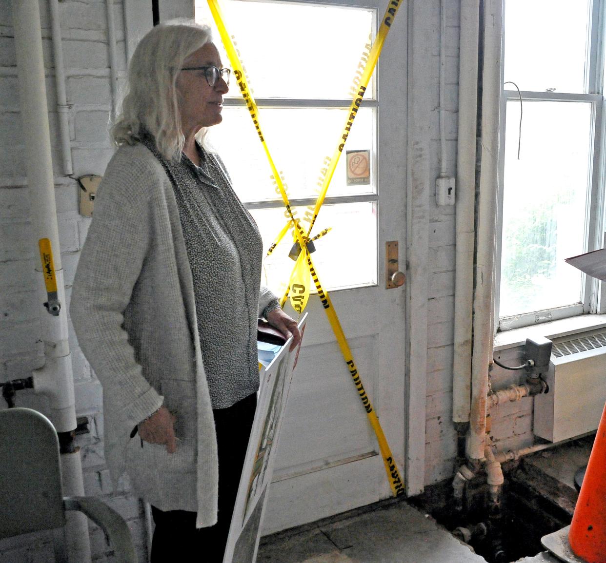 Anne Dorrance shows conditions in a 90-year-old condemned building on the Ohio Agricultural Research & Development Center Wooster campus.