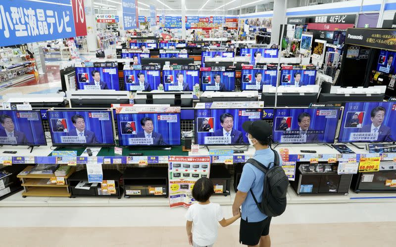 Television screens bradcasting a news conference of Japan's Prime Minister Shinzo Abe are seen at an electric store in Urayasu, Japan