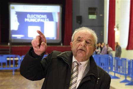 Eugene Binaisse (C), current mayor of Henin Beaumont, gestures as he attends the counting of the votes at a polling station during the first round in the French mayoral elections in Henin Beaumont, Northern France, March 23, 2014. REUTERS/Pascal Rossignol