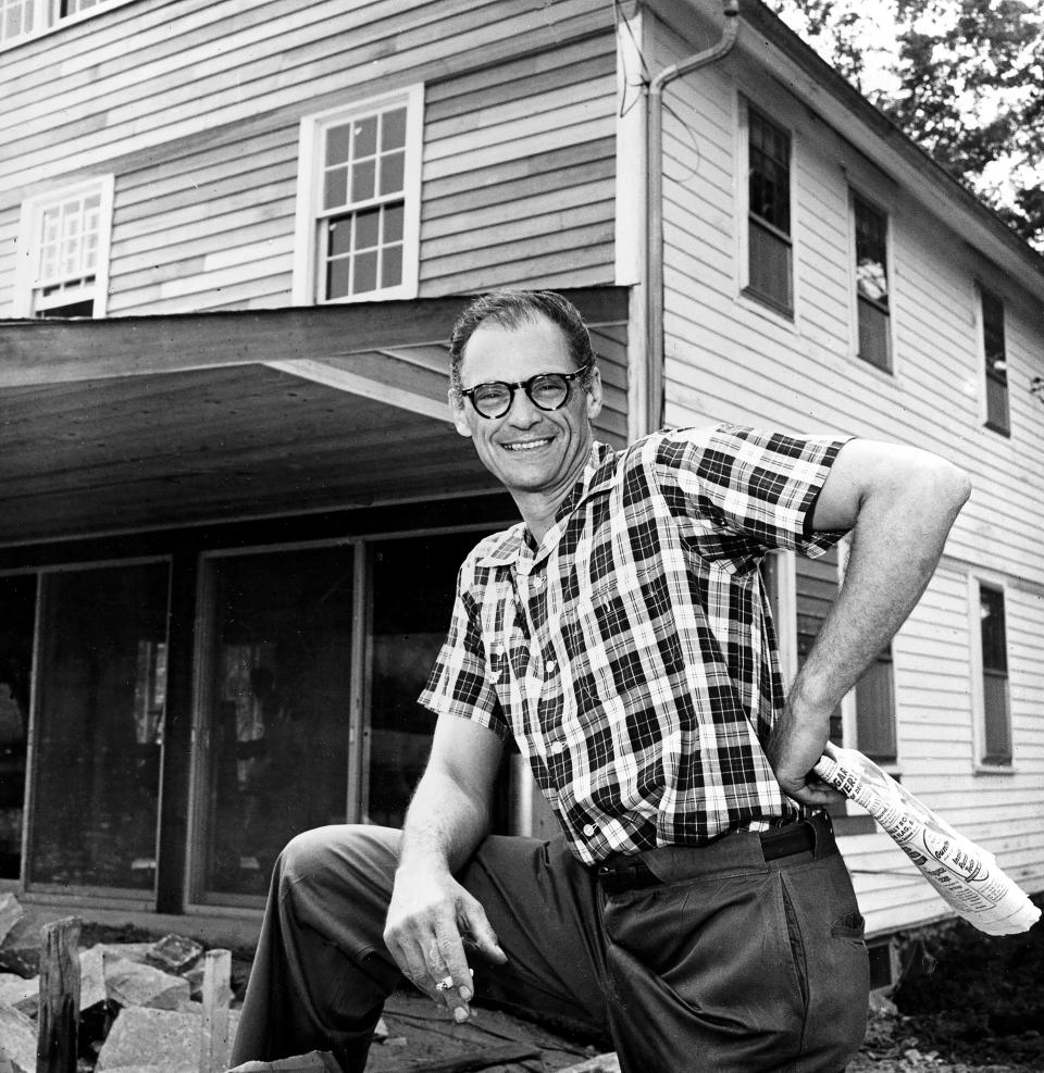FILE - Playwright Arthur Miller poses in front of his farmhouse, where he lives with his actress wife, in Roxbury, Conn., Aug. 7, 1958. Miller's studio, originally built at his former Roxbury home, is where he wrote and revised various plays, his autobiography "Timebends," and screenplays for films "The Misfits" and "The Crucible." The Arthur Miller Writing Studio board, along with Miller's daughter Rebecca Miller, hope to raise $1 million to restore the modest studio structure, relocate it to a nearby local library, and create programming that will inspire other writers. (AP Photo, File)